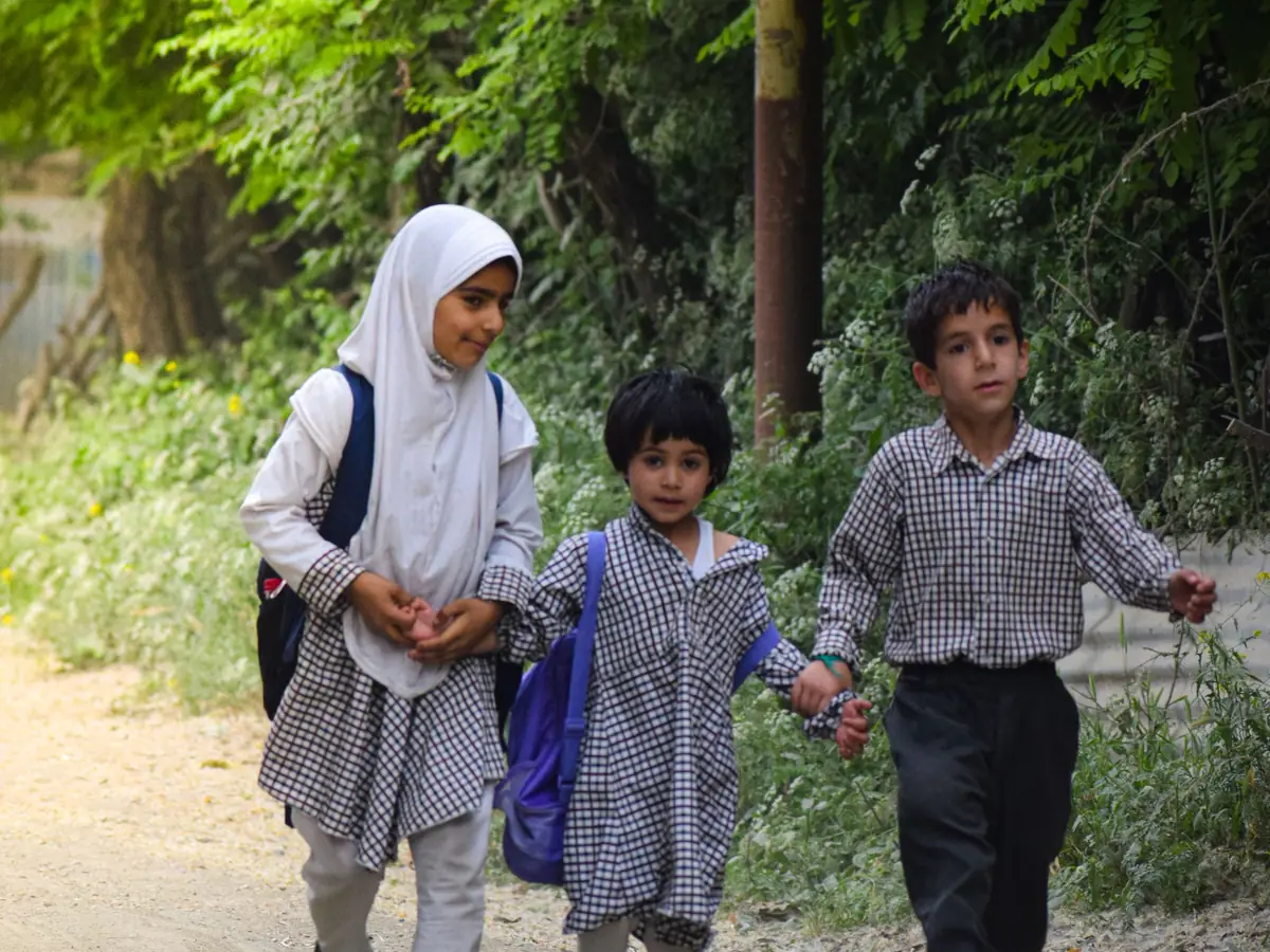 Children in school uniform walking to school together