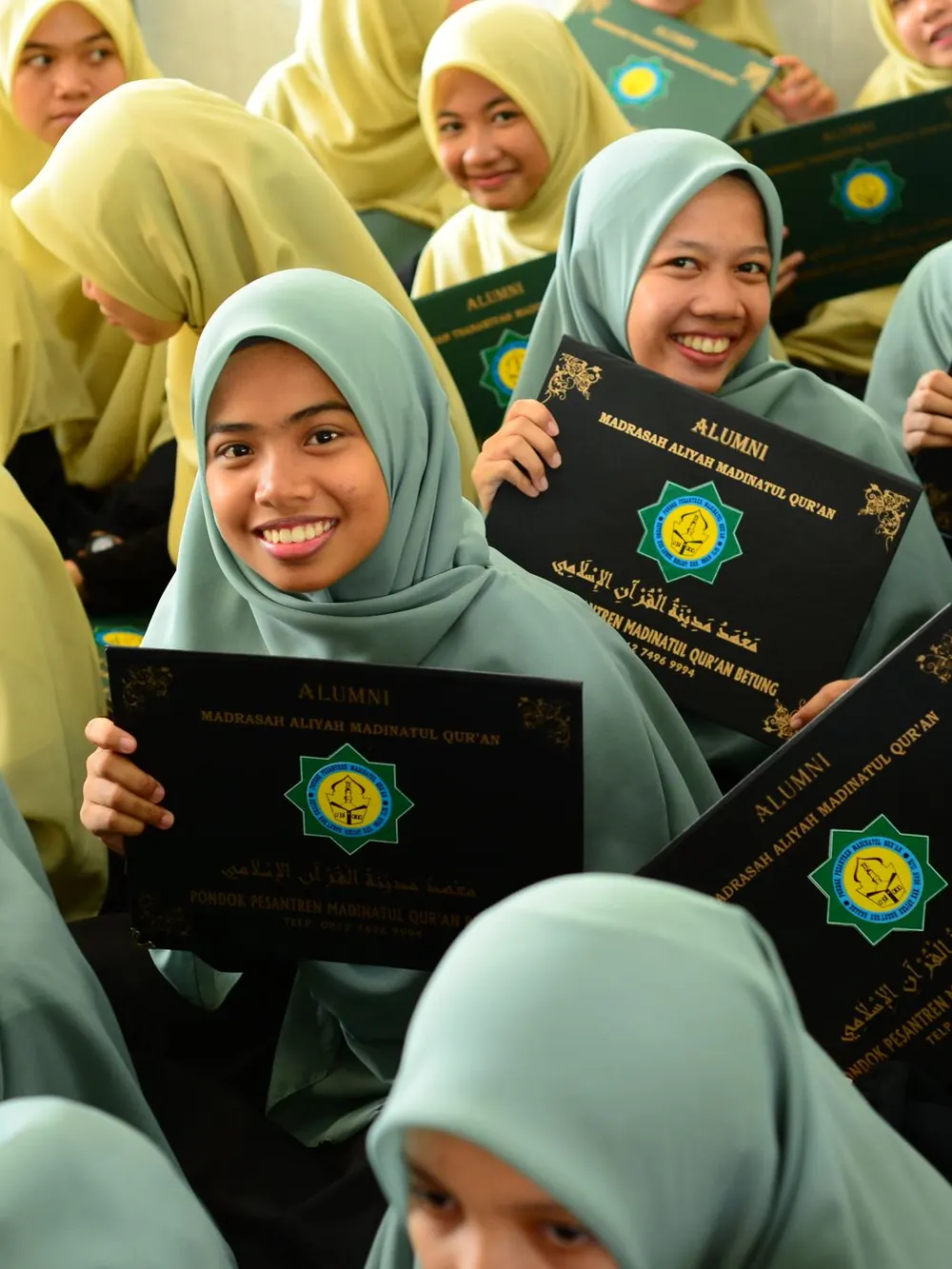 Students holding up their certificates at the annual prize distribution